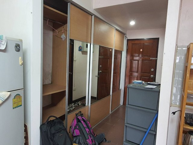 Entrance of the Royal Park Condominium unit with door and wardrobe